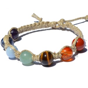 May include: A hemp bracelet with seven colorful gemstone beads. The beads are amethyst, lapis lazuli, aquamarine, aventurine, tiger's eye, carnelian, and red jasper.