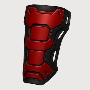 May include: A red and black forearm armor piece. The armor has a geometric design with a red central section and black borders. The piece has a curved shape and is designed to protect the forearm.
