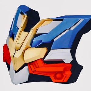 May include: A multi-colored, geometric-shaped object with a futuristic design. The object features a combination of blue, gold, red, white, and black panels. The design has sharp angles and a mechanical aesthetic, suggesting a piece of armor or a futuristic accessory.