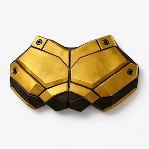 May include: A gold and black segmented chest piece with a geometric design. The chest piece has a metallic gold finish on the upper sections and black accents along the edges. Four black rivets are visible.
