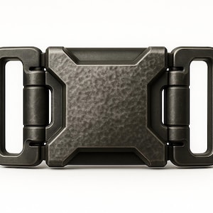 May include: A dark grey metal buckle with a textured centre and rectangular loops on each end. The buckle has a rugged, industrial design, with hinges connecting the centre to the loops.