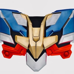 May include: A multi-colored chest plate with a futuristic design. The plate features blue, gold, red, silver, and black panels. The design is symmetrical, with a central gold section flanked by blue and red elements.