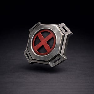May include: A metallic silver-colored emblem with a red "X" symbol inside a circle. The emblem has a geometric, octagonal shape with cut-out details on each corner. The background is a dark, solid color.