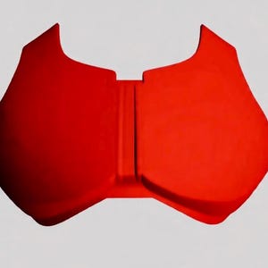May include: A bright red, molded plastic chest protector with a curved shape. The protector has a central vertical ridge and flared upper edges. The item is designed to protect the chest.