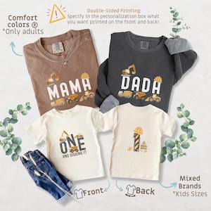 May include: A collection of construction-themed apparel, including brown and gray sweatshirts and cream-colored t-shirts. The shirts feature the words "MAMA," "DADA," and "ONE AND DIGGING IT," along with construction vehicle graphics. A pair of blue jeans is also included.