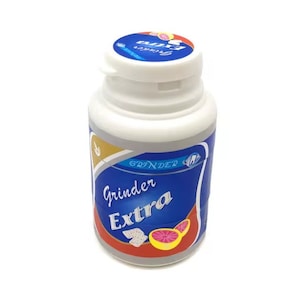 May include: A white plastic container of Grinder Extra chewing gum with a blue and red label. The label features the text "Grinder Extra" and a graphic of a grapefruit slice.