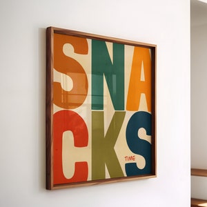 May include: A framed print featuring the word "SNACKS" in large, colourful letters. The letters are in different colours, including red, orange, yellow, green, and blue. The word "TIME" is written in smaller red letters below the word "SNACKS".