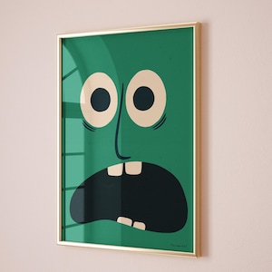 May include: A framed art print depicting a cartoon face with a surprised expression. The face is green with large, off-white eyes, a long nose, and an open black mouth. The frame is gold-coloured, and the background is a light pink.
