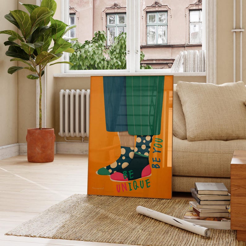 May include: A colorful illustration of legs wearing mismatched socks with polka dots and the text "Be Unique Be You" on a bright orange background.