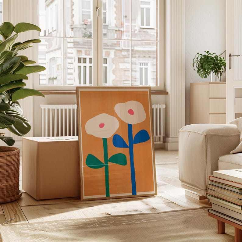 May include: A framed print of two white flowers with pink centers on a yellow background. The flowers have blue and green stems.