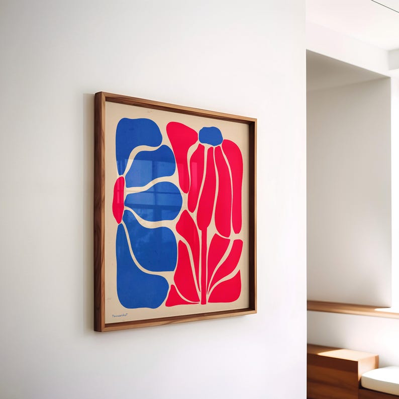 May include: A framed print of a stylized abstract floral design. The print features two large flowers, one blue and one red, on a cream background.