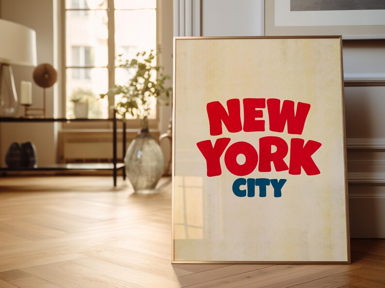 May include: A framed poster with a vintage aesthetic featuring the text "NEW YORK CITY" in bold, red, and blue lettering.