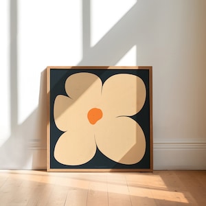 May include: A framed print of a stylized flower with five petals in shades of beige and orange on a dark blue background.