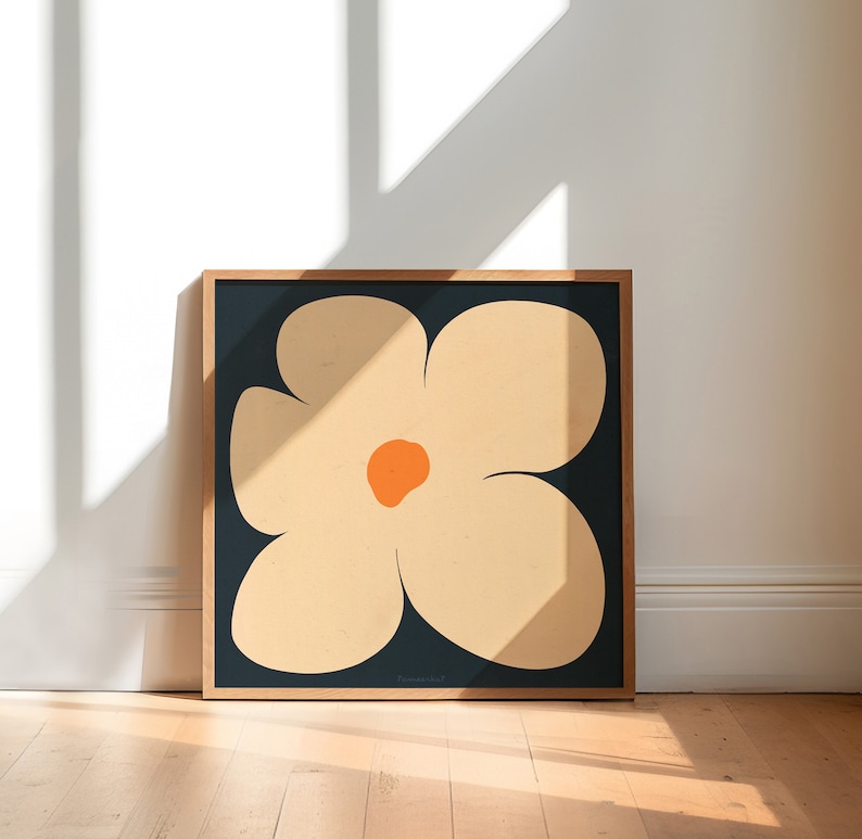 May include: A framed print of a stylized flower with five petals in shades of beige and orange on a dark blue background.