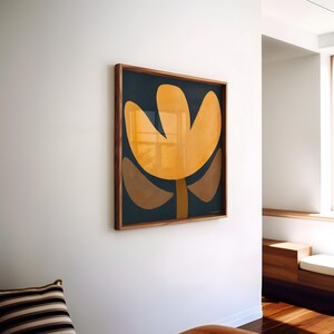 May include: A framed abstract art print with a yellow flower-like shape on a dark blue background.