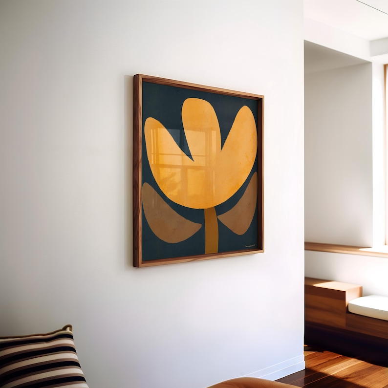 May include: A framed abstract art print with a yellow flower-like shape on a dark blue background.