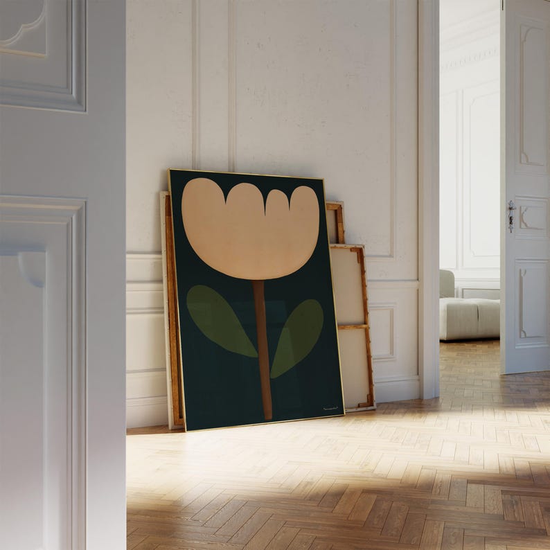 May include: A framed print of a stylized flower with a large, light pink blossom and green leaves on a dark green background.