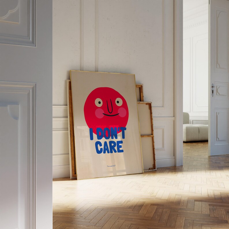 May include: A framed poster with a red cartoon face and the text "I DON'T CARE" in blue letters.