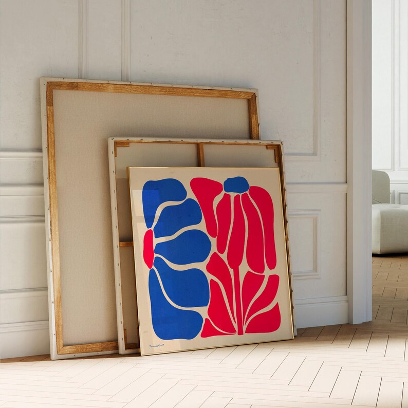 May include: A framed abstract art print featuring a blue and red floral design. The print is on a white background and is framed in a gold frame.