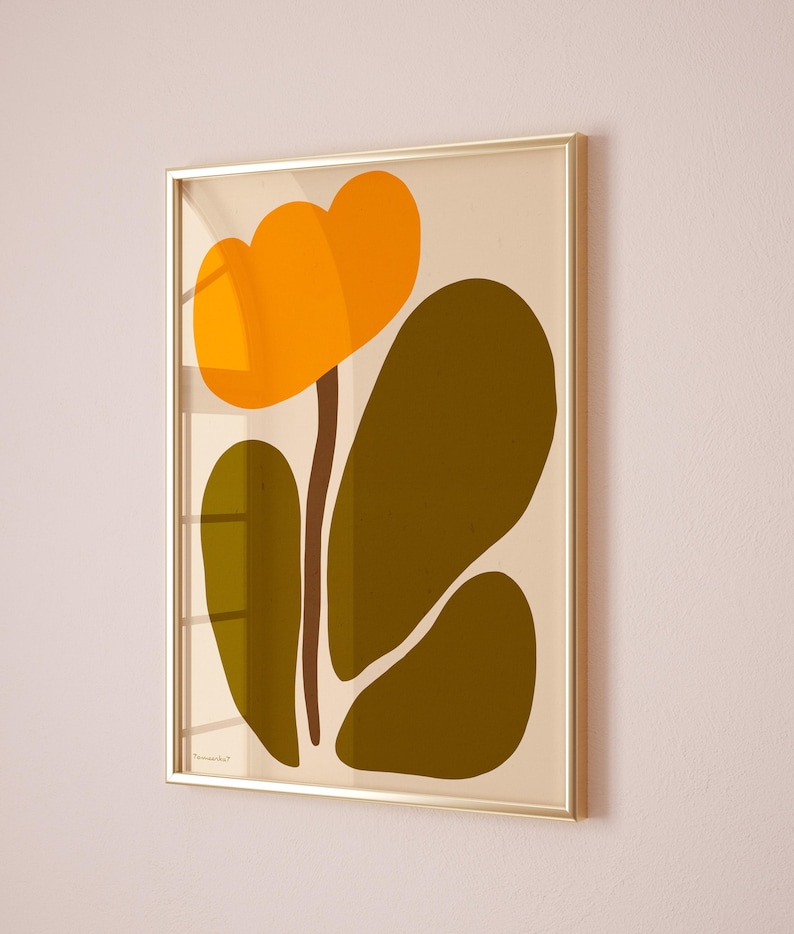 Peut inclure: Une impression abstraite encadr&eacute;e d'une fleur stylis&eacute;e avec des p&eacute;tales orange et une tige brune, sur un fond cr&egrave;me. Les feuilles sont d'un vert fonc&eacute;.