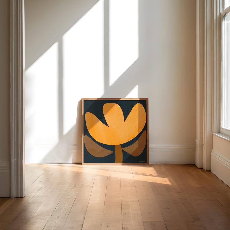 May include: A framed abstract art print with a yellow flower-like shape on a dark blue background.