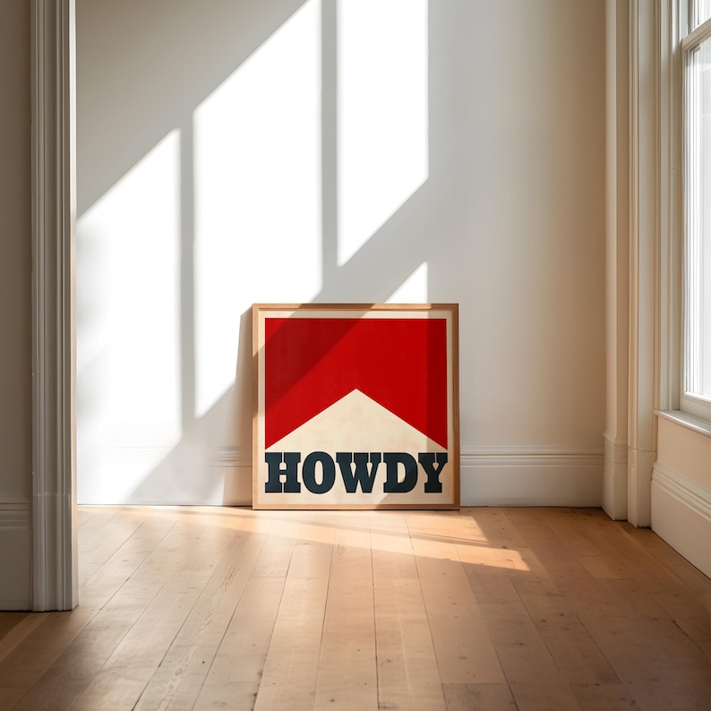 May include: A framed print with a red and white graphic of a cigarette with the word "HOWDY" in black lettering.