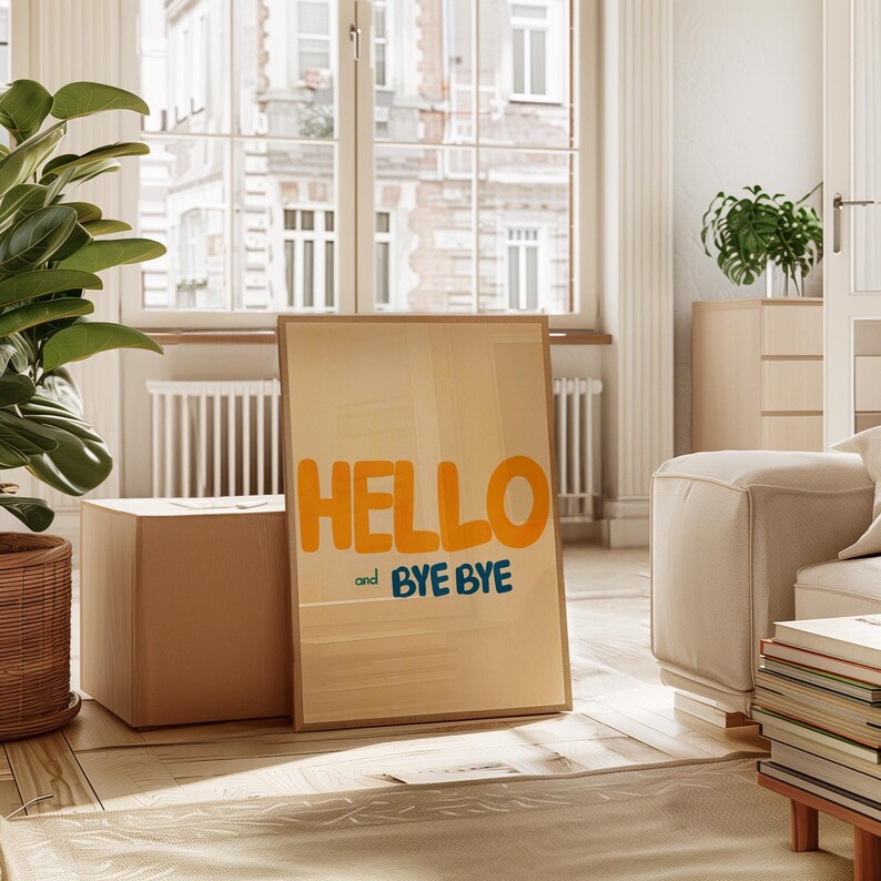 May include: A framed print with the words "HELLO and BYE BYE" in a yellow and blue font on a light brown background.