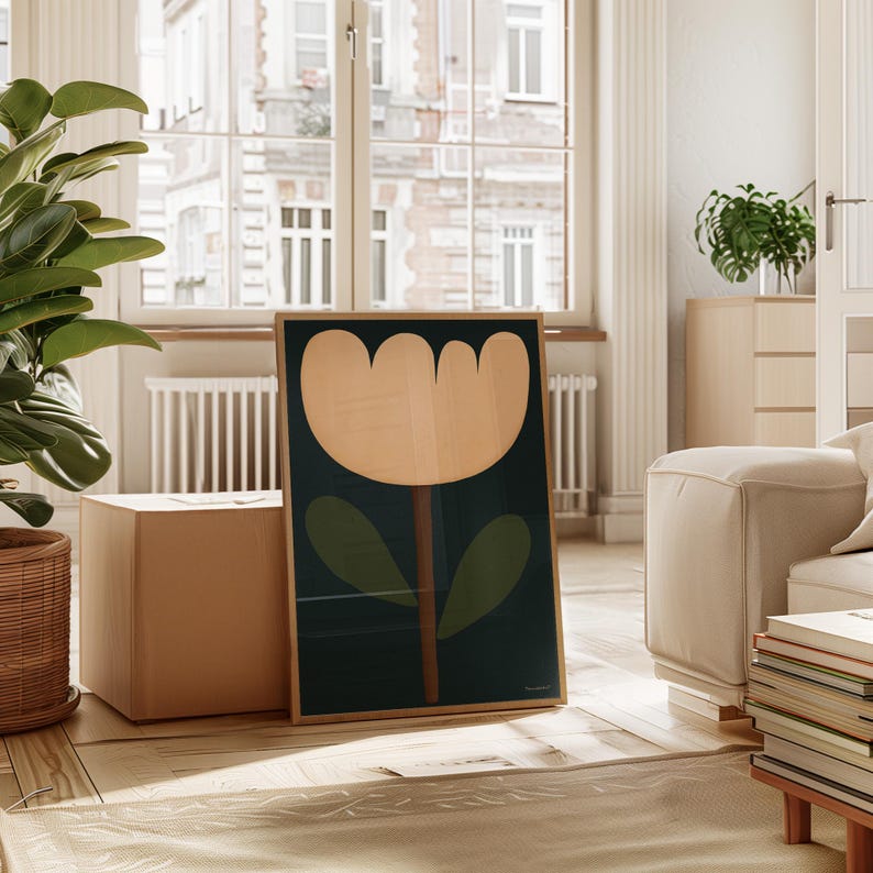 May include: A framed print of a stylized flower with a cream-colored blossom and green leaves on a dark blue background.