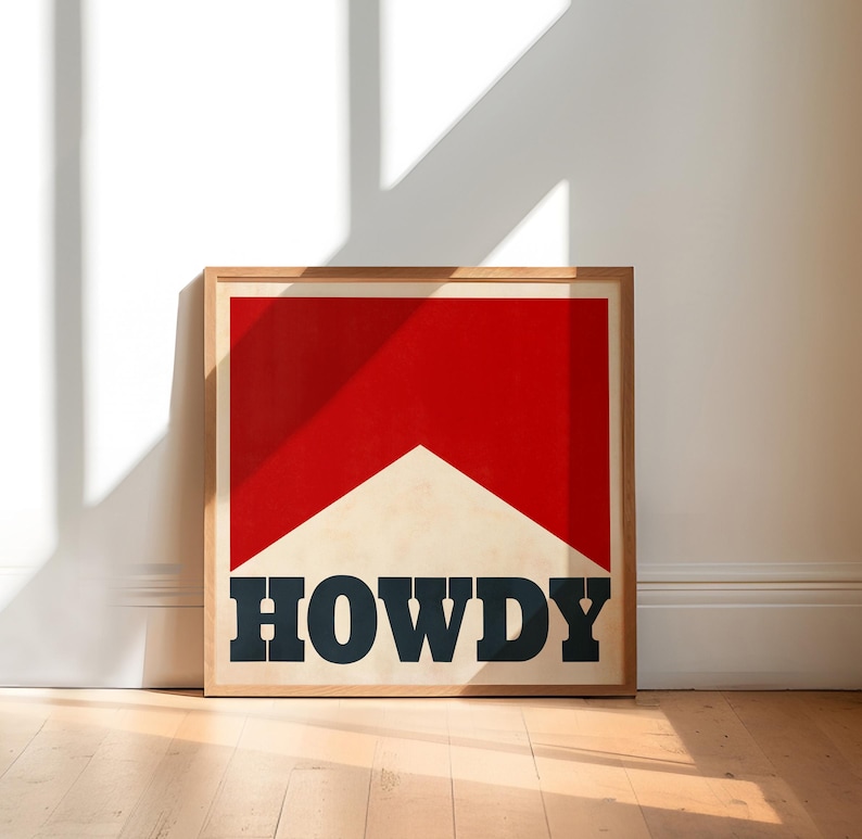 May include: A framed print with a red and white geometric design and the word "HOWDY" in black lettering.