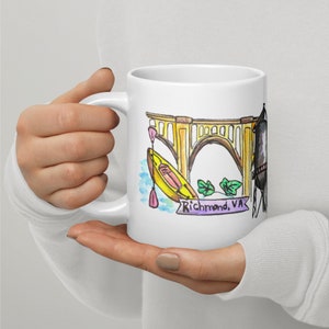 May include: White ceramic mug with a watercolor illustration of a yellow kayak, a bridge, and a water tower. The text "Richmond, VA" is written on a purple banner.