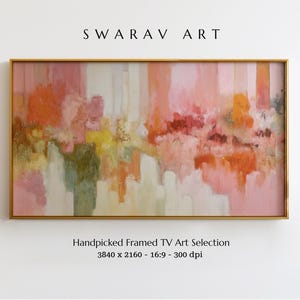 May include: A rectangular framed artwork with an abstract design. The painting features a blend of colours, including pink, orange, yellow, and white, creating a soft, textured appearance. The frame is gold-coloured, and the artwork is labelled "SWARAV ART."
