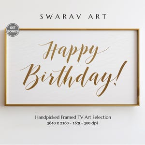 May include: A framed art print with the words "Happy Birthday!" in elegant gold script on a white background. The frame is gold. The text "SWARAV ART" is at the top.