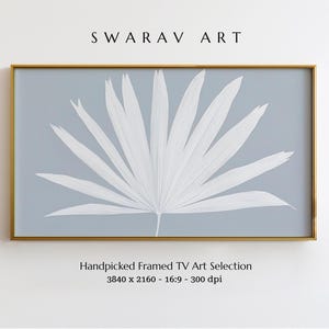 May include: A framed print of a white palm leaf on a light blue background. The print is 3840 x 2160 pixels and 300 dpi. The text "SWARAV ART" and "Handpicked Framed TV Art Selection" is visible below the image.