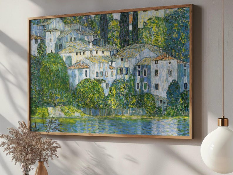 May include: A painting of a village with white houses and green trees, set against a blue sky and a body of water. The houses are clustered together, and the trees are lush and green. The water is calm and reflective, and the sky is clear and blue.