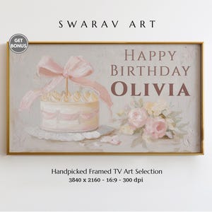 May include: A framed artwork with a birthday theme. The image features a cake with a pink bow, the words "HAPPY BIRTHDAY OLIVIA", and a bouquet of flowers. The artwork is in a gold frame.