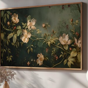 May include: A framed botanical print featuring delicate white flowers with yellow centers, blooming on a dark green vine. The background is a soft, muted green with a hazy, atmospheric effect.