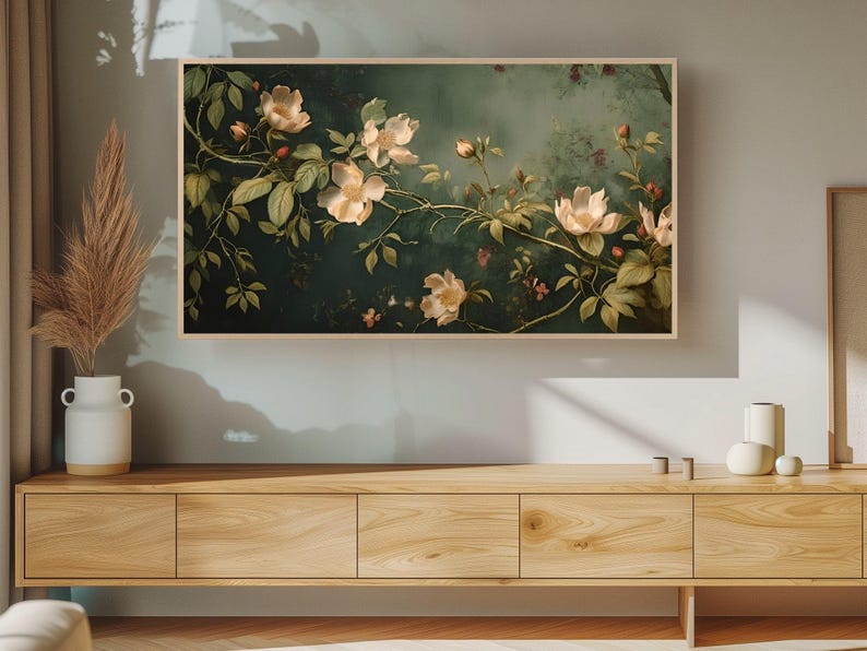 May include: A framed painting of white flowers with green leaves on a dark green background.