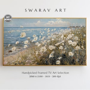May include: A framed painting of a seascape with white flowers in the foreground. The painting is in a gold frame and has a blue sky with white clouds in the background.