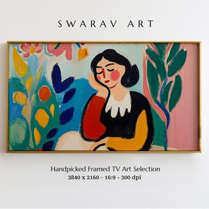 May include: A framed painting of a woman with black hair and a red and yellow dress, sitting in a garden with colorful flowers and leaves. The painting is in a gold frame and has a white background.