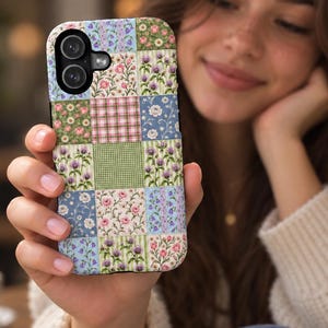 May include: A rectangular smartphone case featuring a multi-coloured patchwork design composed of various floral patterns, small green gingham checks, and pink plaid squares. The case has a black camera cutout area at the top left corner.