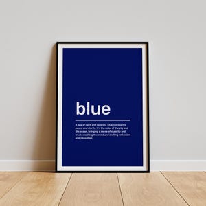 May include: A framed print with a dark blue background and white text that reads "blue". The text below defines the colour blue as a hue of calm and serenity, representing peace and clarity. It is the colour of the sky and the ocean, bringing a sense of stability and trust, soothing the mind and inviting reflection and relaxation.