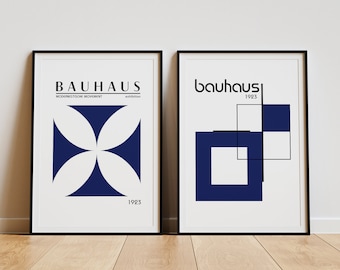 May include: Two framed prints with Bauhaus designs. The left print features a blue and white geometric design with the text "Bauhaus, Modernistische Movement, exhibition, 1923". The right print features a blue geometric design with the text "bauhaus, 1923".