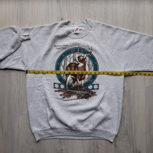 May include: Gray sweatshirt with a print of a deer in a forest scene. The text "Brown County State Park" is printed on the sweatshirt.