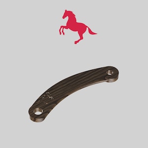 May include: A dark brown wooden boomerang with a carved horse silhouette on one side. The boomerang is curved and has a rounded end.