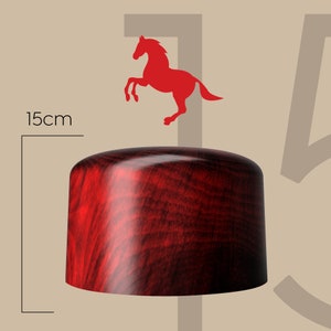 May include: A 15cm diameter red wooden hat with a dark wood grain pattern.