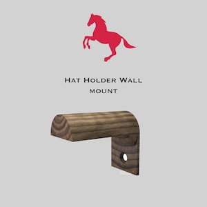 Puede incluir: Un soporte de pared para sombreros de madera. El soporte tiene forma de semicilindro con una base rectangular. El soporte es de color marrón oscuro con un patrón de veta de madera.