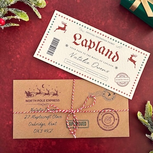 May include: Two Christmas-themed cards on a red surface. One is a Lapland invitation with a reindeer design, the other is a North Pole Express letter tied with red and white twine. Both have text.