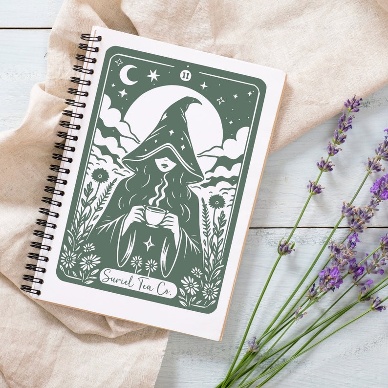 Tarot card design graphic with a mysterious woman wearing a hooded cloak and drinking tea, surrounded by wildflowers, stars and large moon in the sky. Text Suriel Tea Co at the bottom. ACOTAR inspired PNG SVG DXT cut file. Perfect for print on demand
