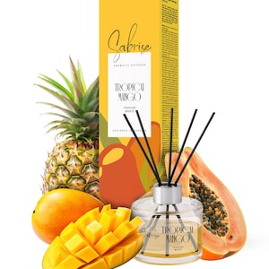May include: Aromatic diffuser with "Tropical Mango" text and black reeds. The product is in a clear glass container with a silver cap. The packaging is yellow with "Sabrise" branding. Mango and papaya slices and a pineapple surround the diffuser.