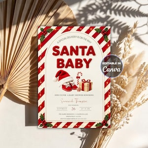 May include: A rectangular baby shower invitation card featuring a red and white candy cane striped border with holly accents. The text reads Santa Baby, A Special Delivery Is On The Way, and includes a graphic of a Santa hat, red baby shoes, and a gift.